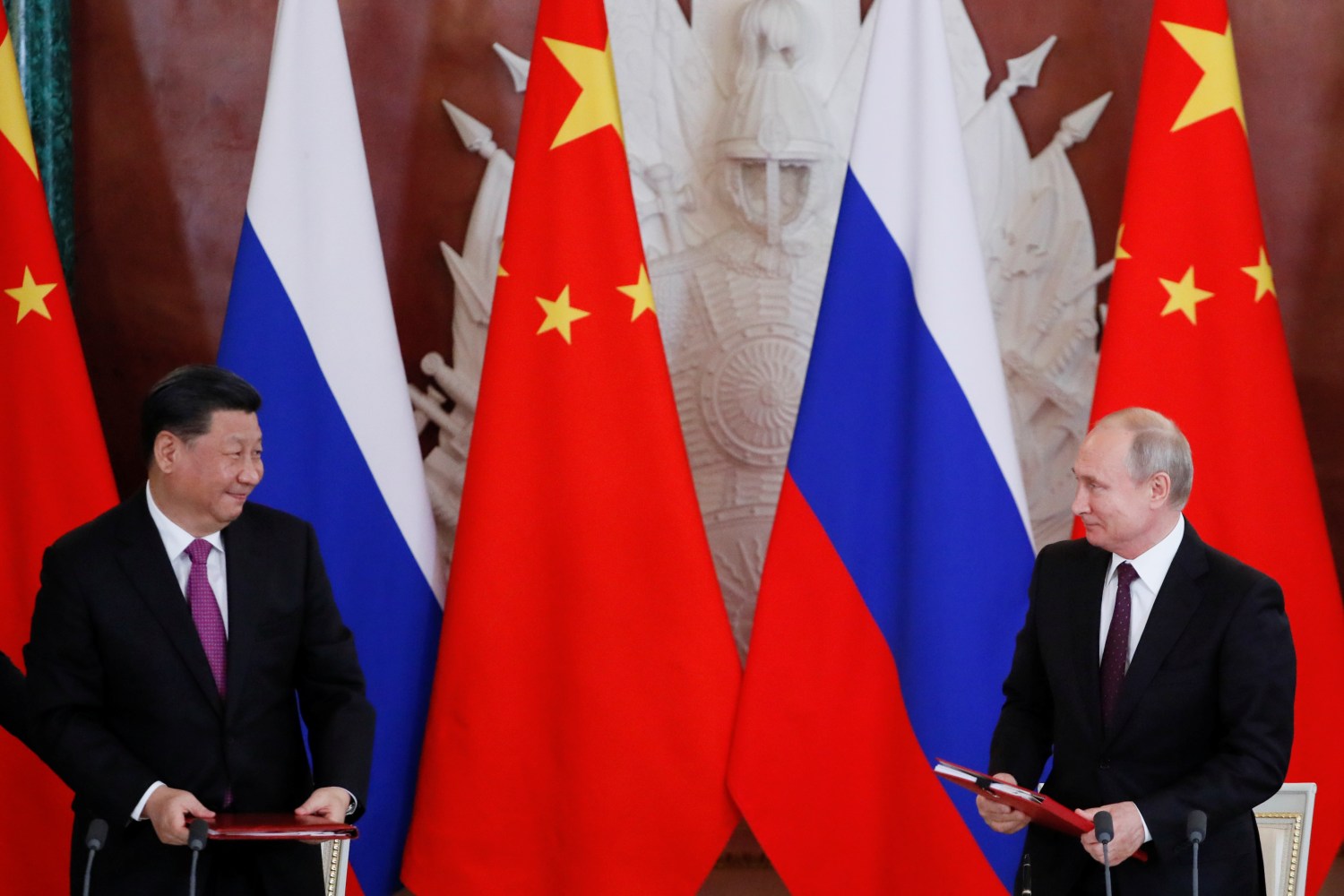Russian President Vladimir Putin and his Chinese counterpart Xi Jinping look on during a signing ceremony in Moscow, Russia, June 5, 2019. REUTERS/Evgenia Novozhenina