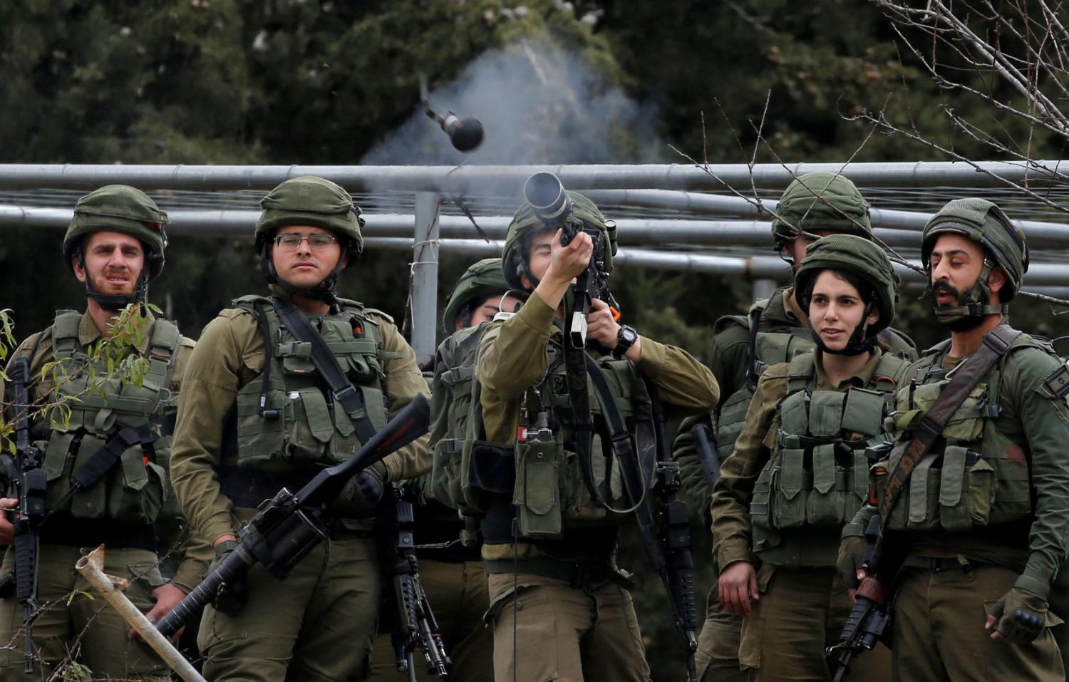 An Israeli soldier fires a tear gas canister towards Palestinian demonstrators during a protest against the U.S. President Donald Trump's Middle East peace plan, in Hebron in the Israeli-occupied West Bank February 2, 2020. REUTERS/Mussa Qawasma
