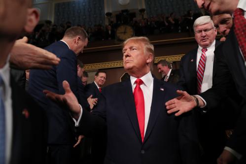 U.S. President Donald Trump is greeted by members of Congress as he arrives to deliver his State of the Union address to a joint session of the U.S. Congress in the House Chamber of the U.S. Capitol in Washington, U.S. February 4, 2020. REUTERS/Leah Millis/POOL