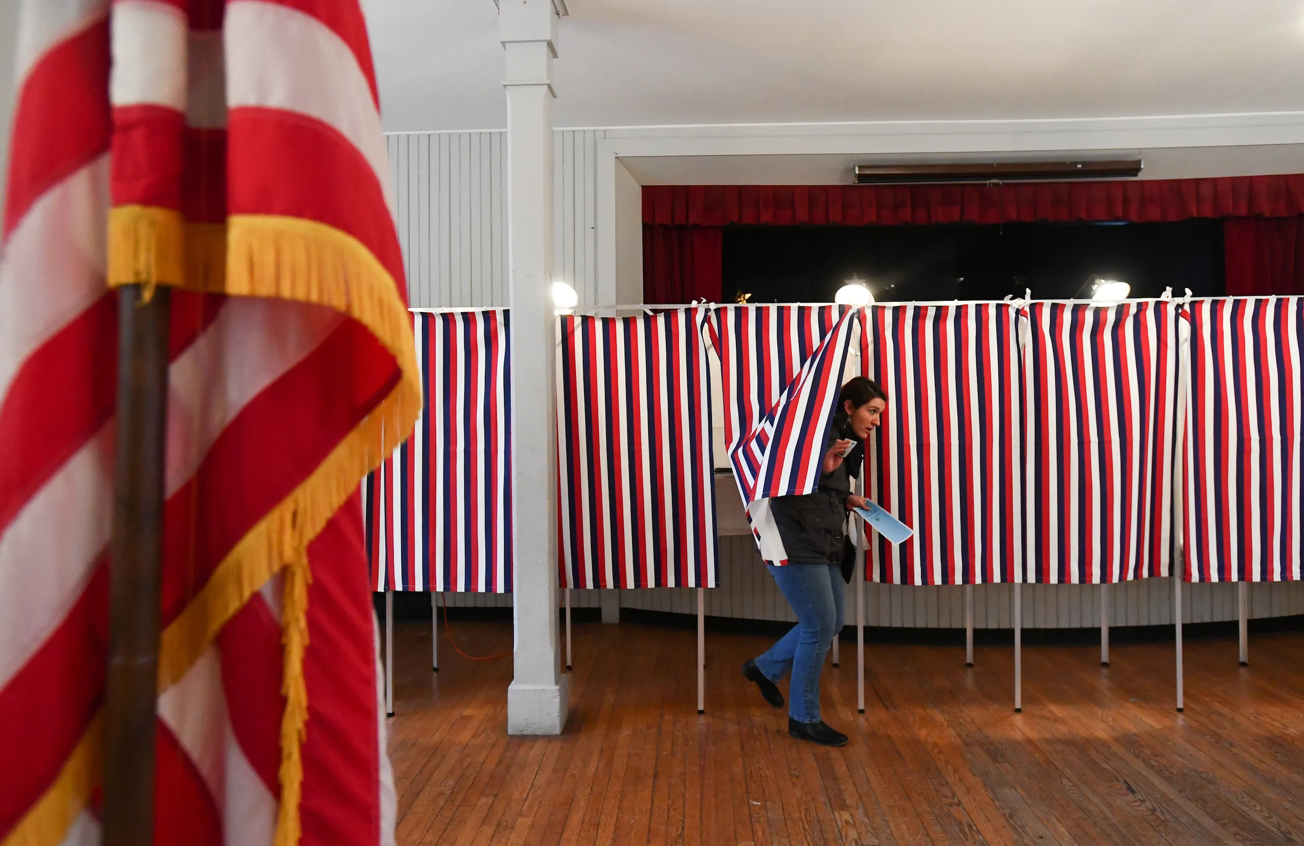 FILE PHOTO: A voter leaves a voting booth after casting her ballot in the state's presidential primary election in Greenfield, New Hampshire, U.S. February 11, 2020.    REUTERS/Gretchen Ertl/File Photo