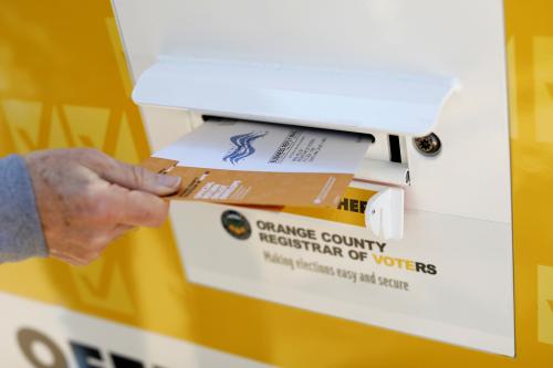 A voter drops ballots for the March 3 Super Tuesday primary into a mobile voting mail box in Laguna Woods, California, U.S., February 24, 2020. Picture taken February 24, 2020.      REUTERS/Mike Blake