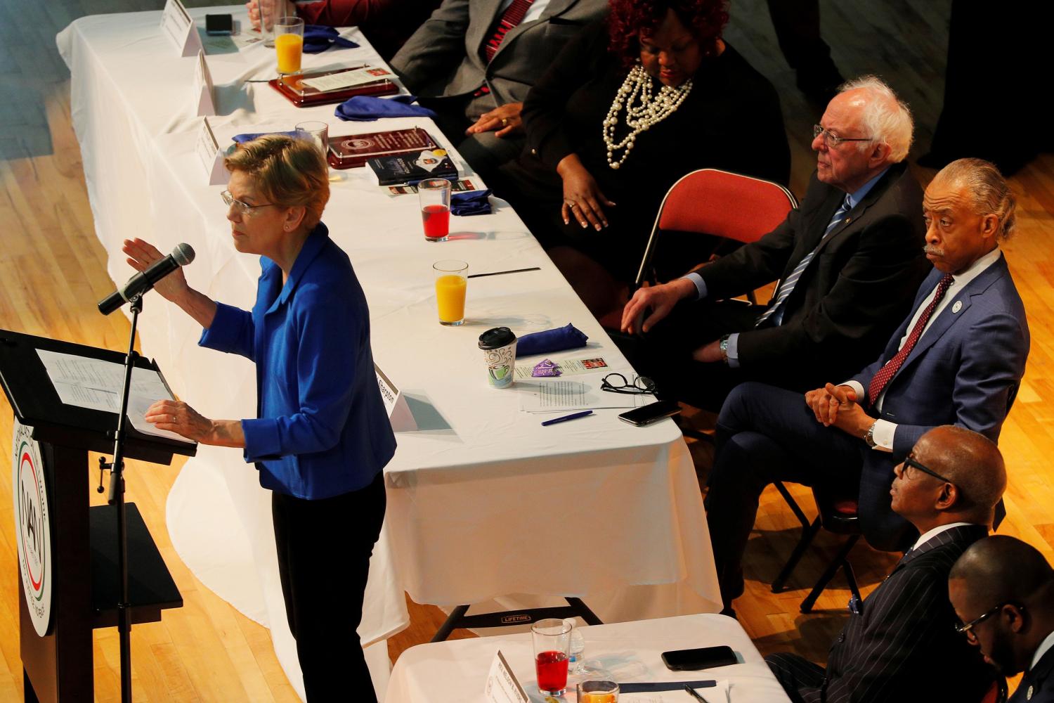 Democratic 2020 U.S. presidential candidate and U.S. Senator Bernie Sanders (I-VT) and Rev. Al Sharpton listen as Democratic 2020 U.S. presidential candidate and U.S. Senator Elizabeth Warren (D-MA) speaks at the NAN South Carolina’s Ministers Breakfast in North Charleston, South Carolina, U.S., February 26, 2020.   REUTERS/Brian Snyder