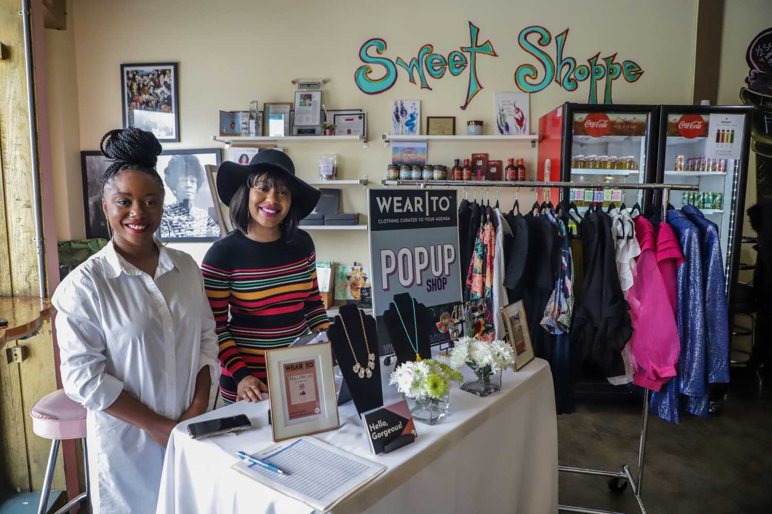 Ashleigh Burden and Quen Carter, of Wear To, clothing curated for the modern woman's agenda, sales items from the online store during the Detroit Black Business Crawl at Good Cakes and Bakes vendor market on the Livernois Avenue of Fashion in Detroit on Small Business Saturday, Nov. 30, 2019.Smallbizsat 113019 Kpm 389