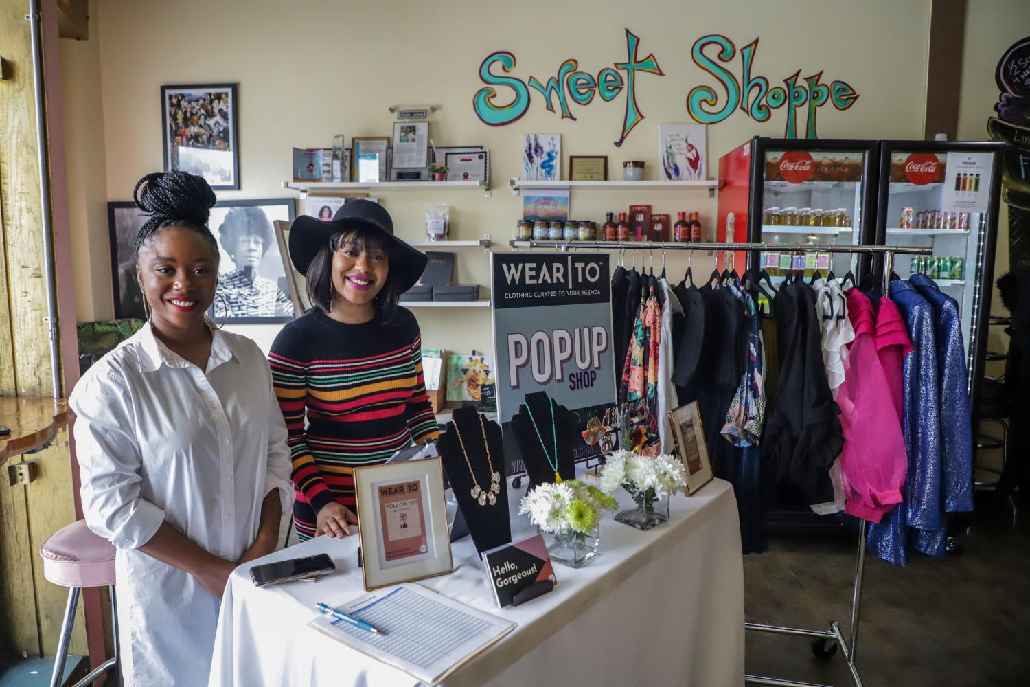Ashleigh Burden and Quen Carter, of Wear To, clothing curated for the modern woman's agenda, sales items from the online store during the Detroit Black Business Crawl at Good Cakes and Bakes vendor market on the Livernois Avenue of Fashion in Detroit on Small Business Saturday, Nov. 30, 2019.Smallbizsat 113019 Kpm 389