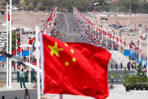 A Chinese national flag flies in front of a Chinese-built main road, before a welcome ceremony for China's President Xi Jinping ahead of the APEC Summit in Port Moresby, Papua New Guinea November 16, 2018. REUTERS/David Gray