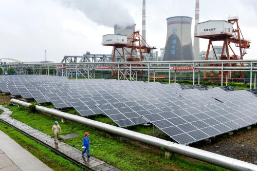 Employees check solar panels, as they work on a grid-connected photovoltaic power generation project, at a power plant in Changxing County, Zhejiang Province, China June 13, 2017. REUTERS/Stringer ATTENTION EDITORS - THIS IMAGE WAS PROVIDED BY A THIRD PARTY. CHINA OUT.