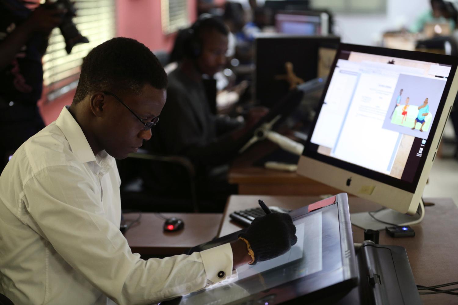 An illustrator works on a digital drawing board at the Kuluya Games office at Anthony district in Nigeria's commercial capital of Lagos June 16, 2014. Industry analysts have long hailed the explosive growth of mobile telecoms in sub-Saharan Africa - 635 million subscribers by the end of 2014 climbing to 930 million by the end of 2019 according to a report by Ericsson. But size isn't everything. It is the quality of those mobile phone connections, subscriptions and surrounding infrastructure that is holding up Africa's nascent games development industry, not the quantity of handsets. Picture taken June 16, 2014. REUTERS/Akintunde Akinleye (NIGERIA - Tags: SCIENCE TECHNOLOGY BUSINESS TELECOMS)