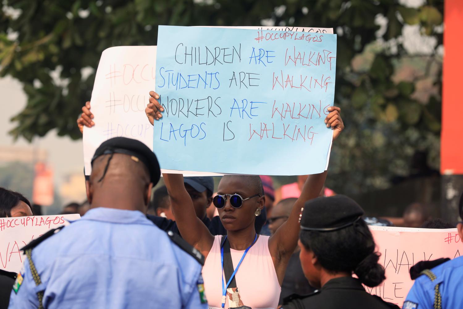 Demonstrators protest with placards against the ban of motorcycles and tricyles in Lagos, Nigeria February 8, 2020. REUTERS/Temilade Adelaja