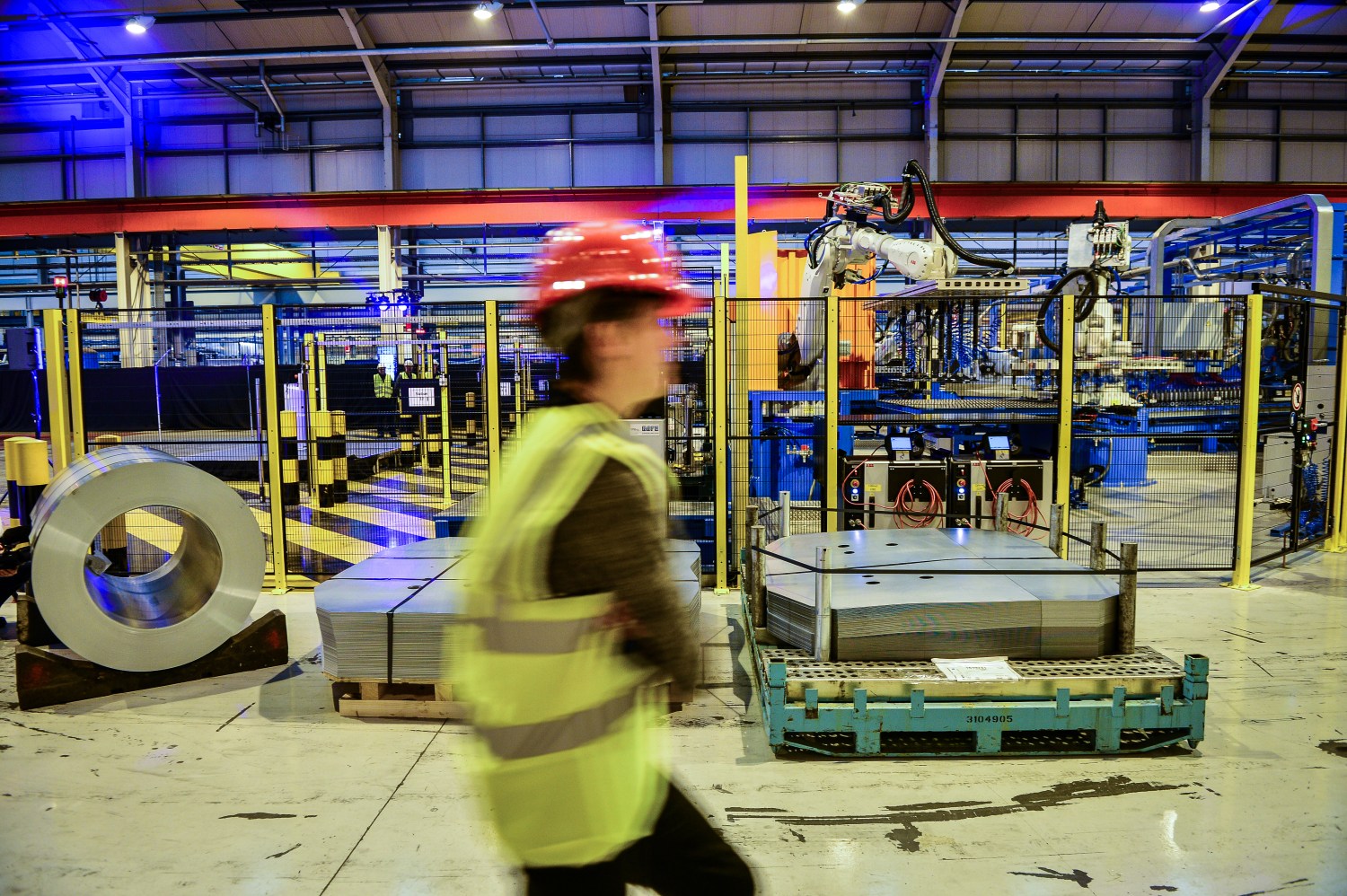 A worker walk spast a Wisco Lasertechnik robotic automated production line at the automotive service centre at Tata Steel's Wednesbury site in Willenhall, Wolverhampton. PRESS ASSOCIATION Photo. Picture date: Wednesday February 15, 2017. Photo credit should read: Ben Birchall