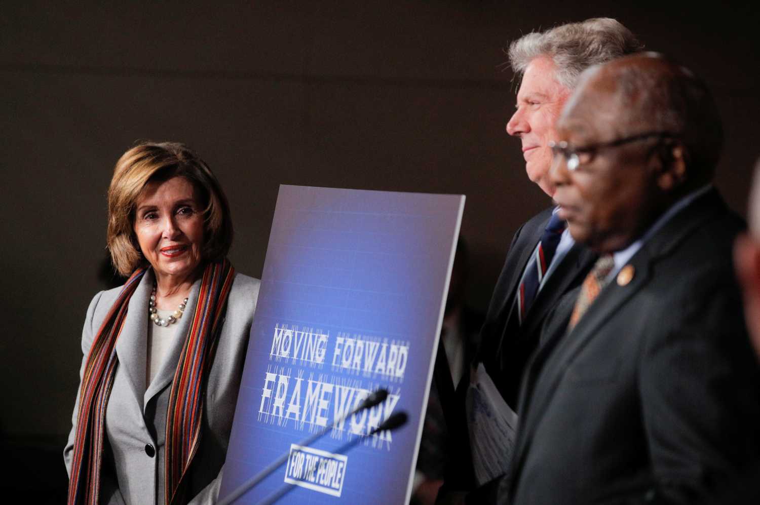 U.S. Speaker of the House Nancy Pelosi listens to House Majority Whip James Clyburn and Energy and Commerce Committee Chairman Frank Pallone Jr. as they hold a news conference to unveil a $760 billion infrastructure spending bill proposed by House Democrats at the U.S. Capitol in Washington, U.S., January 29, 2020. REUTERS/Brendan McDermid