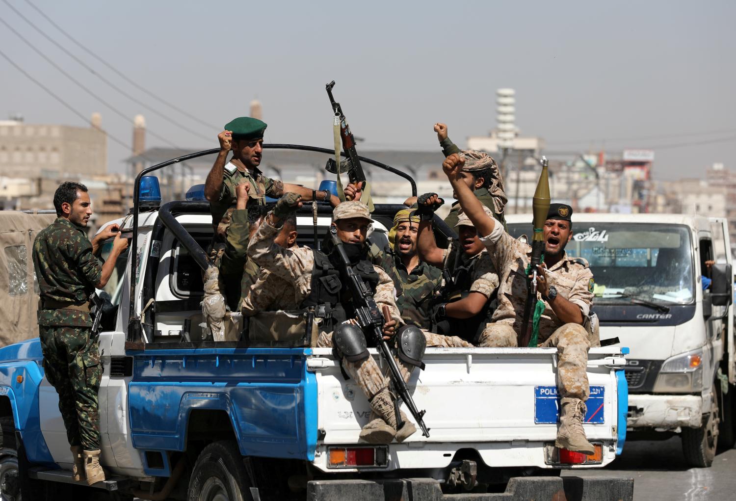 FILE PHOTO: Houthi troops ride on the back of a police patrol truck after participating in a Houthi gathering in Sanaa, Yemen February 19, 2020. REUTERS/Khaled Abdullah/File Photo