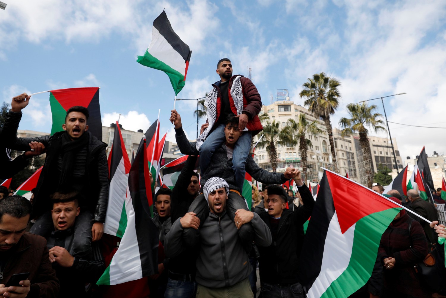 Palestinian demonstrators take part in a rally in support of President Mahmoud Abbas and against the U.S. President Donald Trump's Middle East peace plan, in Ramallah in the Israeli-occupied West Bank February 11, 2020. REUTERS/Mohamad Torokman
