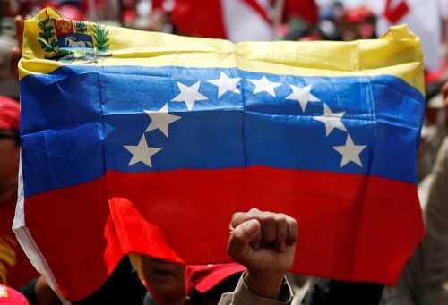 A supporter of Venezuela's President Nicolas Maduro raises his fist during a rally against the report of U.N. High Commissioner for Human Rights Michelle Bachelet, in Caracas, Venezuela July 13, 2019. REUTERS/Carlos Garcia Rawlins
