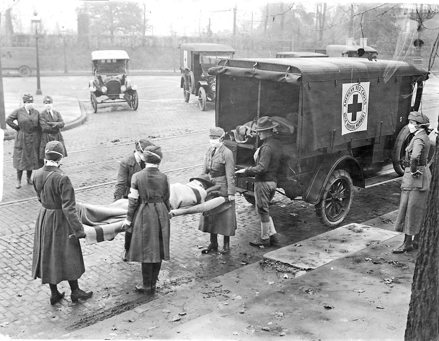 Members of the American Red Cross remove Spanish influenza victims from a house at Etzel and Page avenues in 1918. (St. Louis Post-Dispatch file photo/TNS/ABACAPRESS.COM)