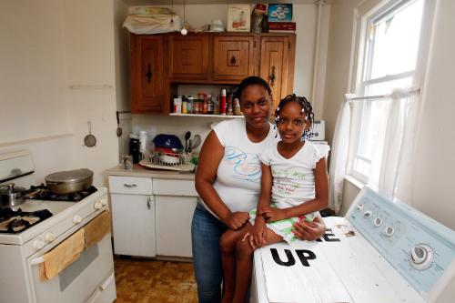 Tashawna Green,  21, poses for a portrait with her daughter, Taishaun, 6, at her home in Queens Village, New York August 21, 2011. Green who up until recently worked 25 hours a week at Target, is on food stamps and says a good number of her colleagues are too. Green made $8.08 cents an hour working for Target. "It's a good thing that the government helps, but if employers paid enough and gave enough hours, then we wouldn't need to be on food stamps." Picture taken August 21, 2011.  To match Insight USA-POVERTY-FOODSTAMPS/           REUTERS/Jessica Rinaldi (UNITED STATES - Tags: SOCIETY)