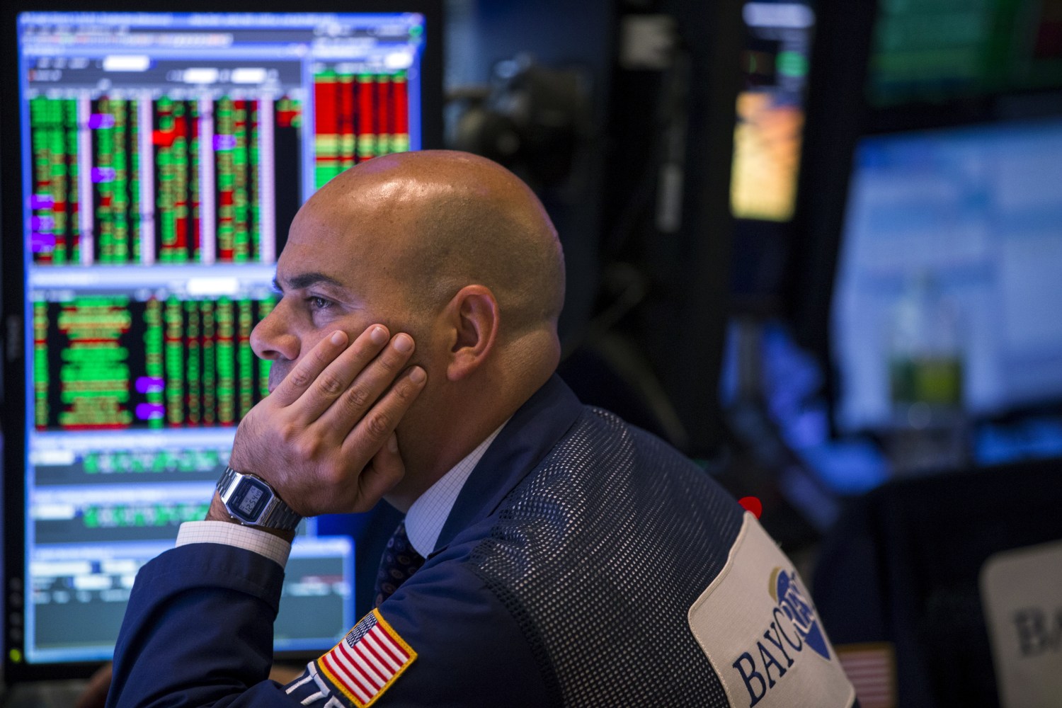 A trader looks at stock prices on a screen while working on the floor of the New York Stock Exchange shortly before the closing bell in New York August 26, 2015. Wall Street was sharply higher on Wednesday while European shares and commodities prices fell as investors balanced strong U.S. economic data and interest rate comments with fears about China's slowing economy.   REUTERS/Lucas Jackson