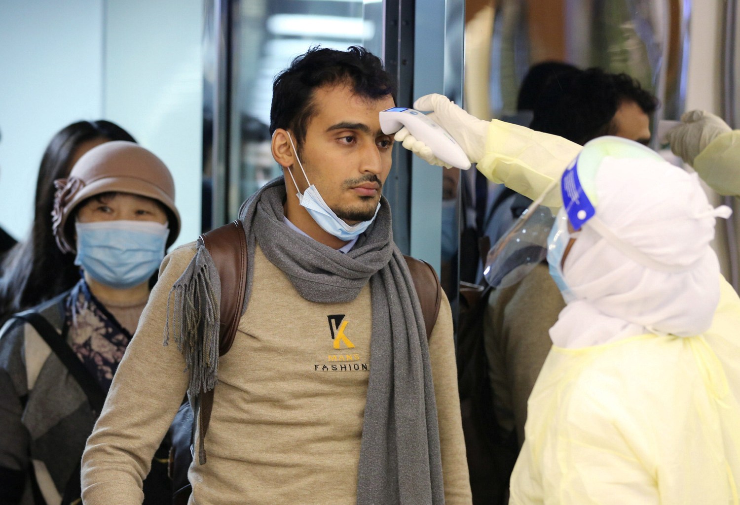Passengers coming from China wearing masks to prevent a new coronavirus are checked by Saudi Health Ministry employees upon their arrival at King Khalid International Airport, in Riyadh, Saudi Arabia January 29, 2020. REUTERS/Ahmed Yosri
