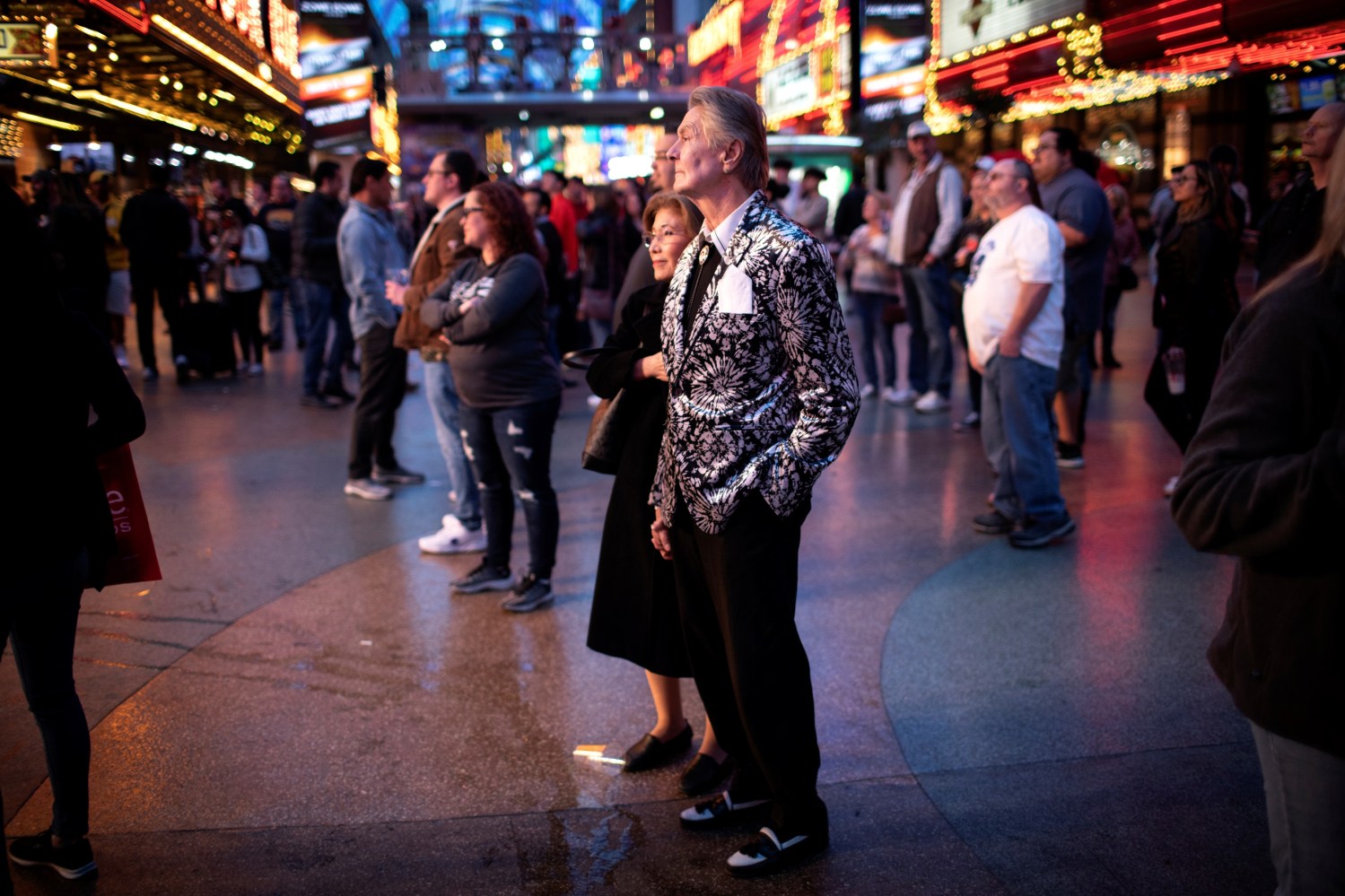 A couple watches street performers in downtown in Las Vegas, Nevada, U.S., February 20, 2020. Picture taken February 20, 2020. REUTERS/Mike Segar