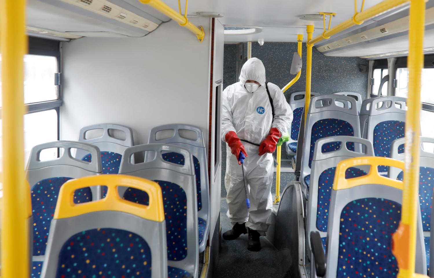 A staff member at city transport company wearing protective clothing disinfects a bus as new coronavirus disease (COVID-19) cases are reported in Skopje, North Macedonia March 7, 2020.REUTERS/Ognen Teofilovski