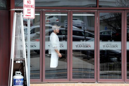 A worker looks out from a near empty restaurant on North Avenue during the coronavirus outbreak in New Rochelle, New York, U.S., March 11, 2020. REUTERS/Mike Segar