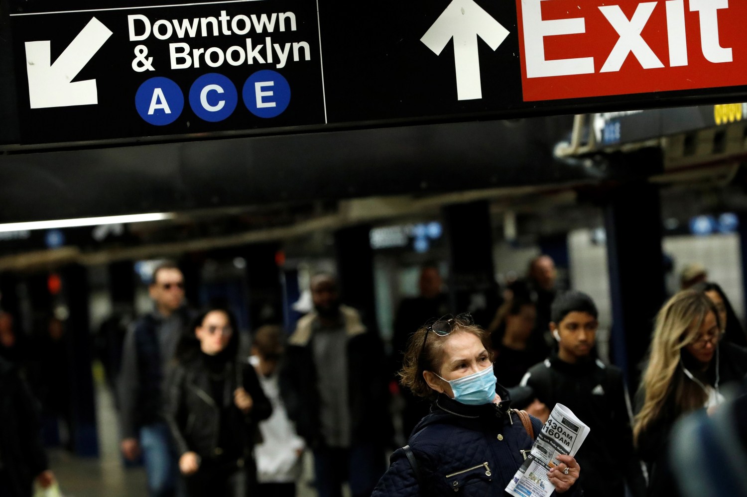 A person in a surgical mask walks through the 42nd Street Subway Station as the coronavirus outbreak continued in Manhattan, New York City, New York, U.S., March 13, 2020. REUTERS/Andrew Kelly