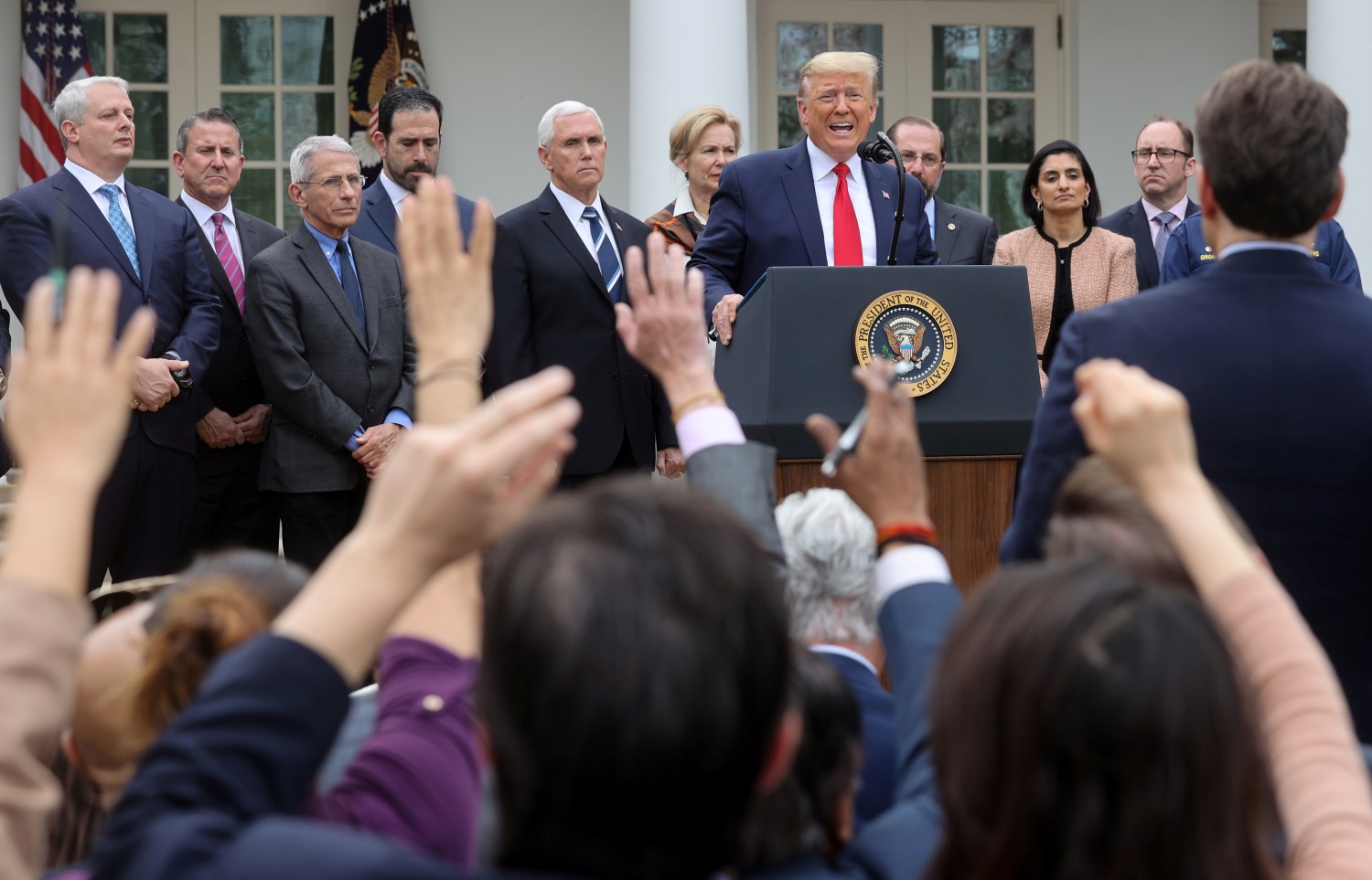 U.S. President Donald Trump is accompanied by National Institute of Allergy and Infectious Diseases Director Anthony Fauci, coronavirus task force members and industry executives as he takes questions at a news conference where he declared the coronavirus pandemic a national emergency in the Rose Garden of the White House in Washington, U.S., March 13, 2020. REUTERS/Jonathan Ernst