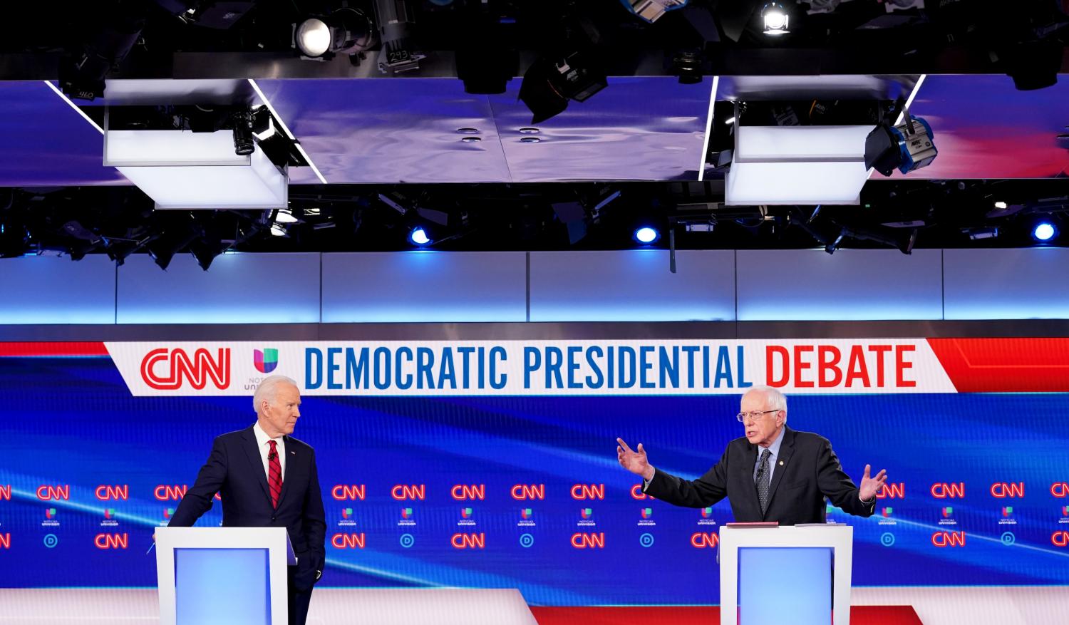 Democratic U.S. presidential candidate former Vice President Joe Biden listens as Senator Bernie Sanders speaks during the 11th Democratic candidates debate of the 2020 U.S. presidential campaign, held in CNN's Washington studios without an audience because of the global coronavirus pandemic, in Washington, U.S., March 15, 2020. REUTERS/Kevin Lamarque