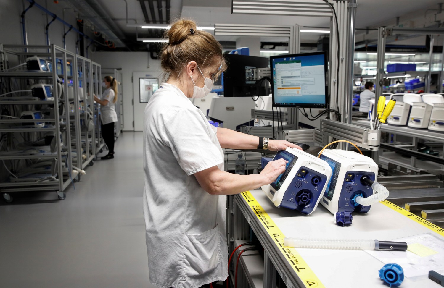 Employees of Hamilton Medical AG test ventilators at a plant in Domat/Ems, Switzerland March 18, 2020. REUTERS/Arnd Wiegmann