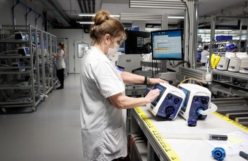 Employees of Hamilton Medical AG test ventilators at a plant in Domat/Ems, Switzerland March 18, 2020. REUTERS/Arnd Wiegmann