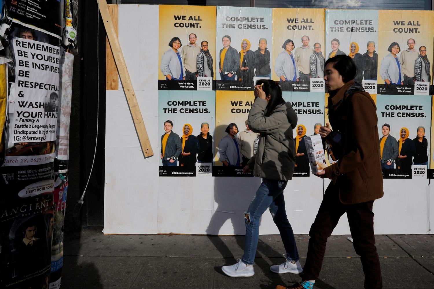 Signs advertising the 2020 U.S. Census cover a closed and boarded up business amid the coronavirus disease (COVID-19) outbreak in Seattle, Washington, U.S., March 23, 2020.  REUTERS/Brian Snyder