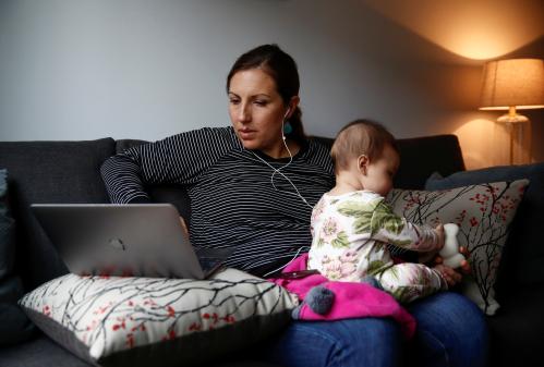 Seattle City Councilmember Teresa Mosqueda watches her infant daughter Camila Valdes-Mosqueda as she checks in to a council meeting by phone due to the council's temporary work from home policy during the coronavirus disease (COVID-19) outbreak in Seattle, Washington, U.S. March 23, 2020. REUTERS/Lindsey Wasson