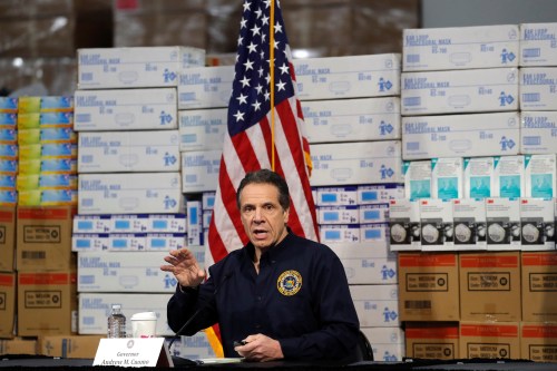 New York Governor Andrew Cuomo speaks in front of stacks of medical protective supplies during a news conference at the Jacob K. Javits Convention Center, which will be partially converted into a temporary hospital during the outbreak of the coronavirus disease (COVID-19) in New York City, New York, U.S., March 24, 2020. REUTERS/Mike Segar