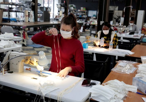 FILE PHOTO: Analiese Zaleski sews hospital masks, as the spread of coronavirus disease (COVID-19) continues, on day one of turning the Detroit Sewn facility into a production facility for hospital masks in Pontiac, Michigan, U.S., March 23, 2020.      REUTERS/Rebecca Cook -