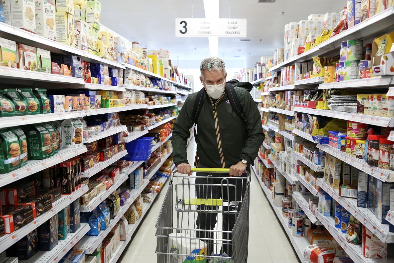 Doug Hassebroek shops with a protective mask during the outbreak of coronavirus disease (COVID-19) in Brooklyn, New York, U.S., March 25, 2020. Picture taken March 25, 2020. REUTERS/Caitlin Ochs