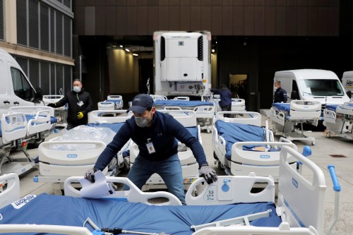 A worker moves part of a delivery of 64 hospital beds from Hillrom to The Mount Sinai Hospital during the outbreak of the coronavirus disease (COVID-19) in Manhattan, New York City, U.S., March 31, 2020. REUTERS/Andrew Kelly