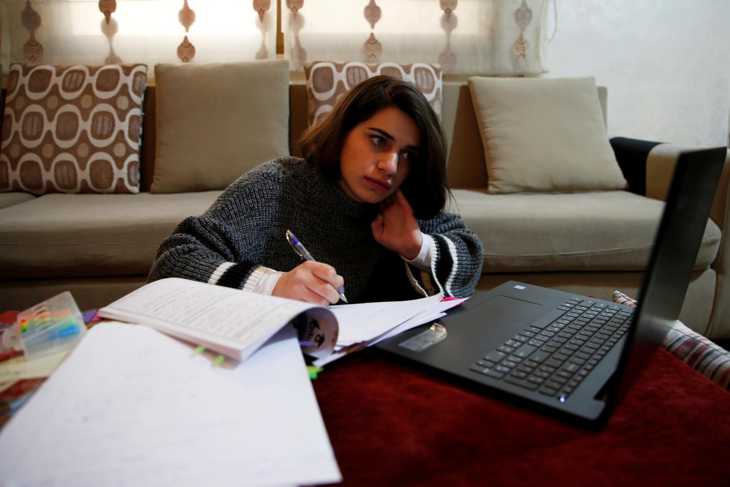High school student, Mona Hussein participates in an online class at her home, after coronavirus lockdown forced schools to close, amid concerns over the spread of coronavirus disease (COVID-19), in Amman, Jordan March 23, 2020. Picture taken March 23, 2020. REUTERS/Muhammad Hamed