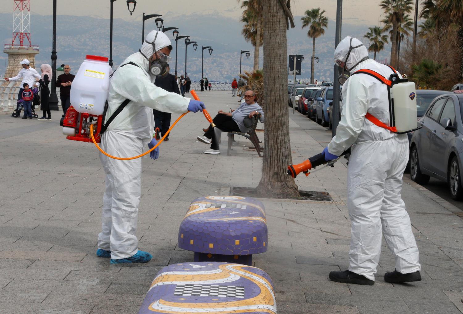 Employees from a disinfection company sanitize a bench as a precaution against the spread of the coronavirus, at Beirut's seaside Corniche, Lebanon March 5, 2020. REUTERS/Mohamed Azakir