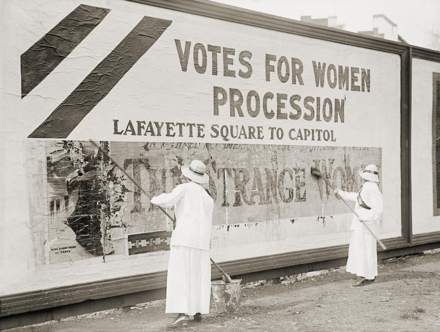 Women suffragists cover a billboard to advertise their Washington, D.C. parade. Nation-wide demonstrations were held in May 1914 to support the Federal Amendment enfranchising women (Shutterstock)