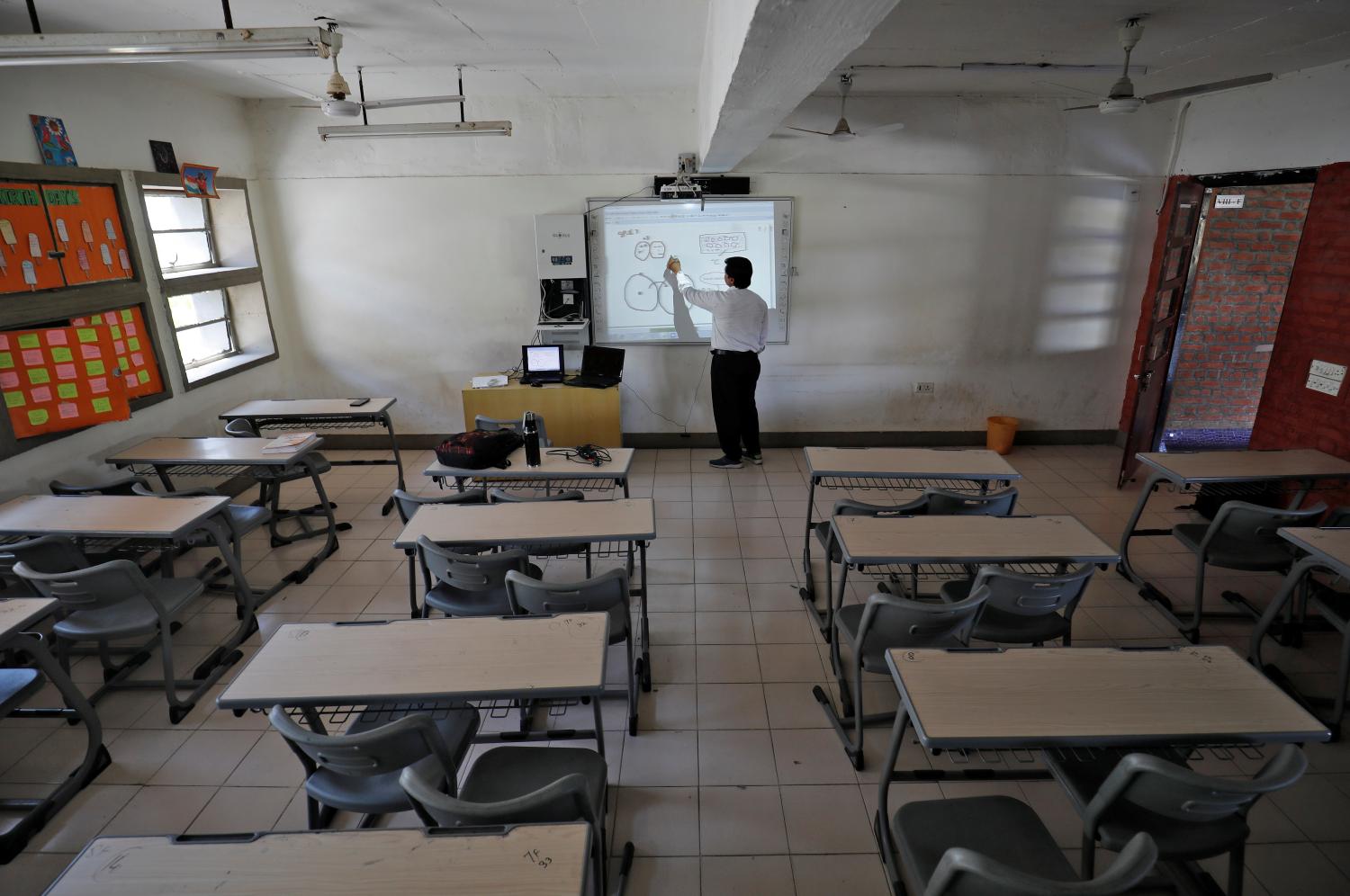A teacher takes an online class for his students inside a private school after Gujarat government ordered the closure of schools and colleges across the state amid coronavirus fears, in Ahmedabad, India, March 17,2020. REUTERS/Amit Dave