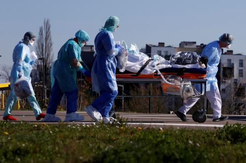 FILE PHOTO: A patient infected with coronavirus is carried on a stretcher by a French rescue team before being transferred by a helicopter of the civil security (Securite Civile) from Strasbourg university hospital to Pforzheim in Germany as the spread of the coronavirus disease (COVID-19) continues, in France, March 24, 2020. REUTERS/Christian Hartmann/File Photo