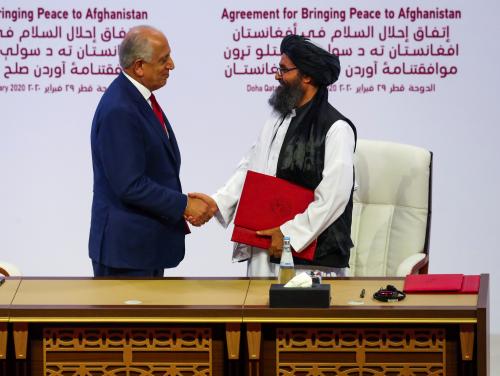 FILE PHOTO: Mullah Abdul Ghani Baradar, the leader of the Taliban delegation, and Zalmay Khalilzad, U.S. envoy for peace in Afghanistan, shake hands after signing an agreement at a ceremony between members of Afghanistan's Taliban and the U.S. in Doha, Qatar, February 29, 2020. REUTERS/Ibraheem al Omari/File Photo
