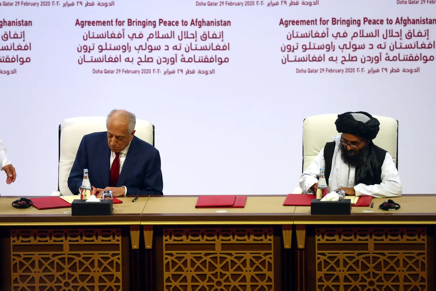 Mullah Abdul Ghani Baradar, the leader of the Taliban delegation, signs an agreement with Zalmay Khalilzad, U.S. envoy for peace in Afghanistan, at a signing agreement ceremony between members of Afghanistan's Taliban and the U.S. in Doha, Qatar February 29, 2020. REUTERS/Ibraheem al Omari