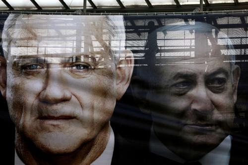 FILE PHOTO: A banner depicts Benny Gantz, leader of Blue and White party, and Israel Prime minister Benjamin Netanyahu, as part of Blue and White party's campaign ahead of the upcoming election, in Tel Aviv, Israel February 17, 2020. REUTERS/Ammar Awad/File Photo