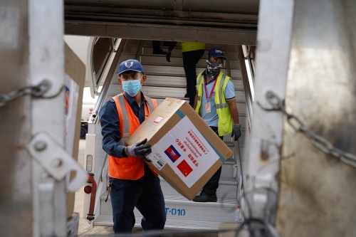 Medical supplies are carried from a plane as a flight arrives from China to Cambodia with supplies and doctors to contain the spread of the coronavirus disease (COVID-19) outbreak, at Phnom Penh International Airport in Cambodia, March 23, 2020. REUTERS/Cindy Liu NO RESALES NO ARCHIVES
