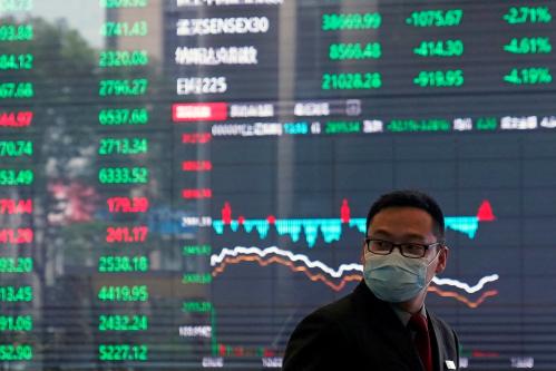 A man wearing a protective mask is seen inside the Shanghai Stock Exchange building, as the country is hit by a new coronavirus outbreak, at the Pudong financial district in Shanghai, China February 28, 2020. REUTERS/Aly Song