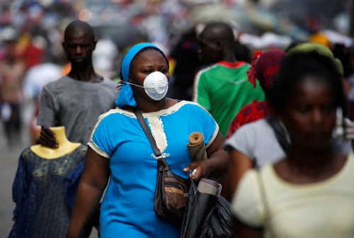 A Woman wears a protective mask as she walks on a street in Adjame an area of Abidjan, Ivory Coast, March 17, 2020. REUTERS/Luc Gnago