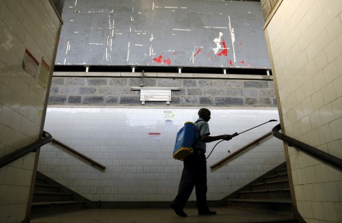 An employee of Kenyan railway cooperation sprays disinfectant to prevent the spread of coronavirus disease (COVID-19), at the main railway station in Nairobi, Kenya, March 17, 2020. REUTERS/Baz Ratner