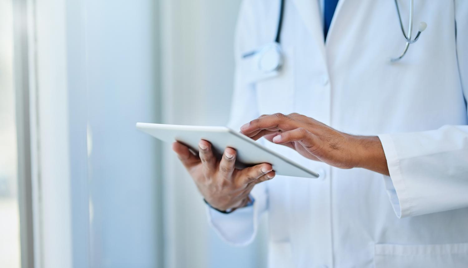 Closeup shot of an unrecognizable doctor using a digital tablet in a hospital