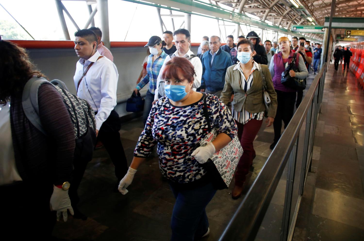 A commuter wearing a protective face mask walks inside metro installations as the outbreak of coronavirus disease (COVID-19) continues, in Mexico City, Mexico March 24, 2020. REUTERS/Gustavo Graf