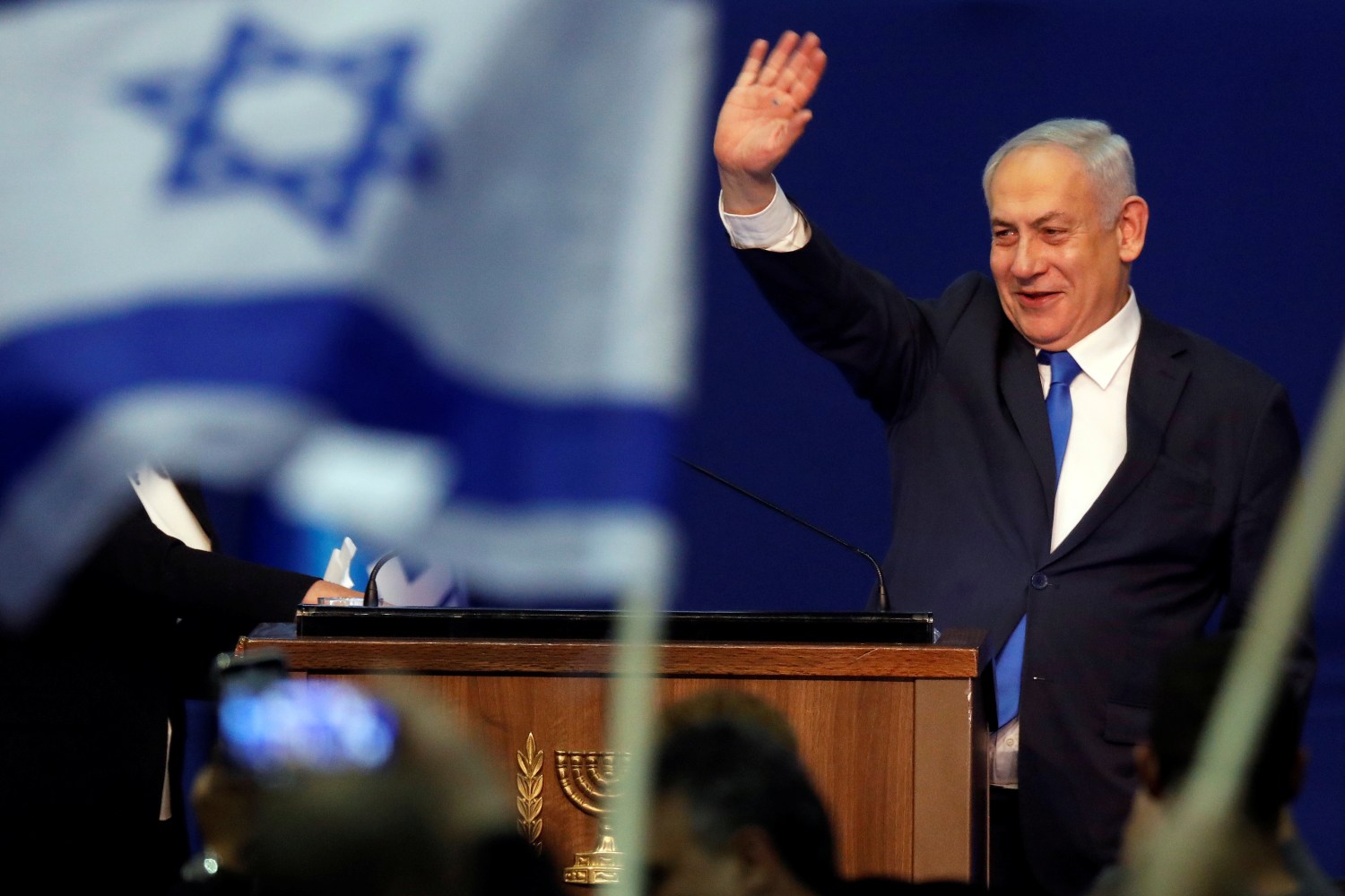 Israeli Prime Minister Benjamin Netanyahu waves to supporters following the announcement of exit polls in Israel's election at his Likud party headquarters in Tel Aviv, Israel March 3, 2020. REUTERS/Amir Cohen